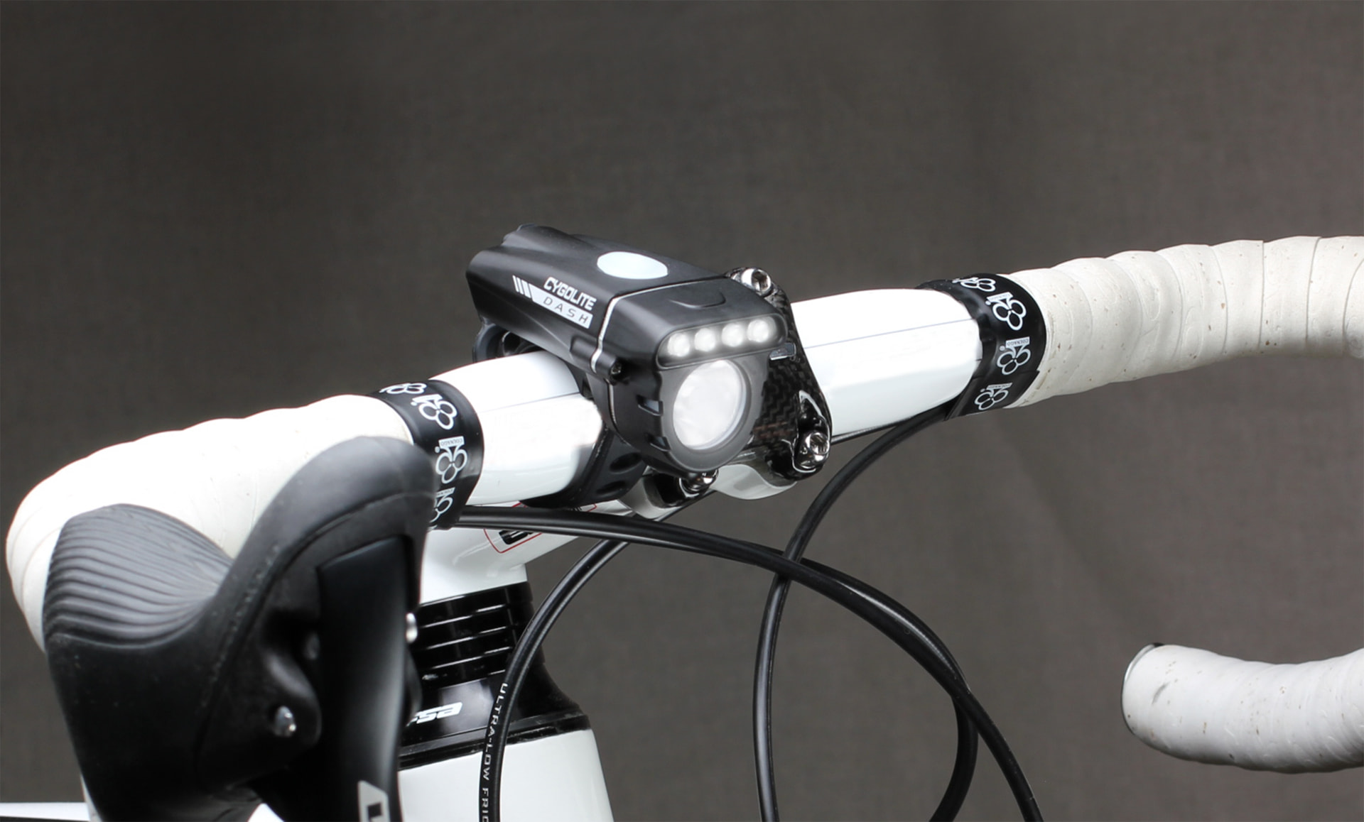 Cygolite Dash 320 headlight mounted on a white road bike handlebar