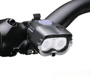 Dual lens Cygolite headlight mounted on a bike handlebar