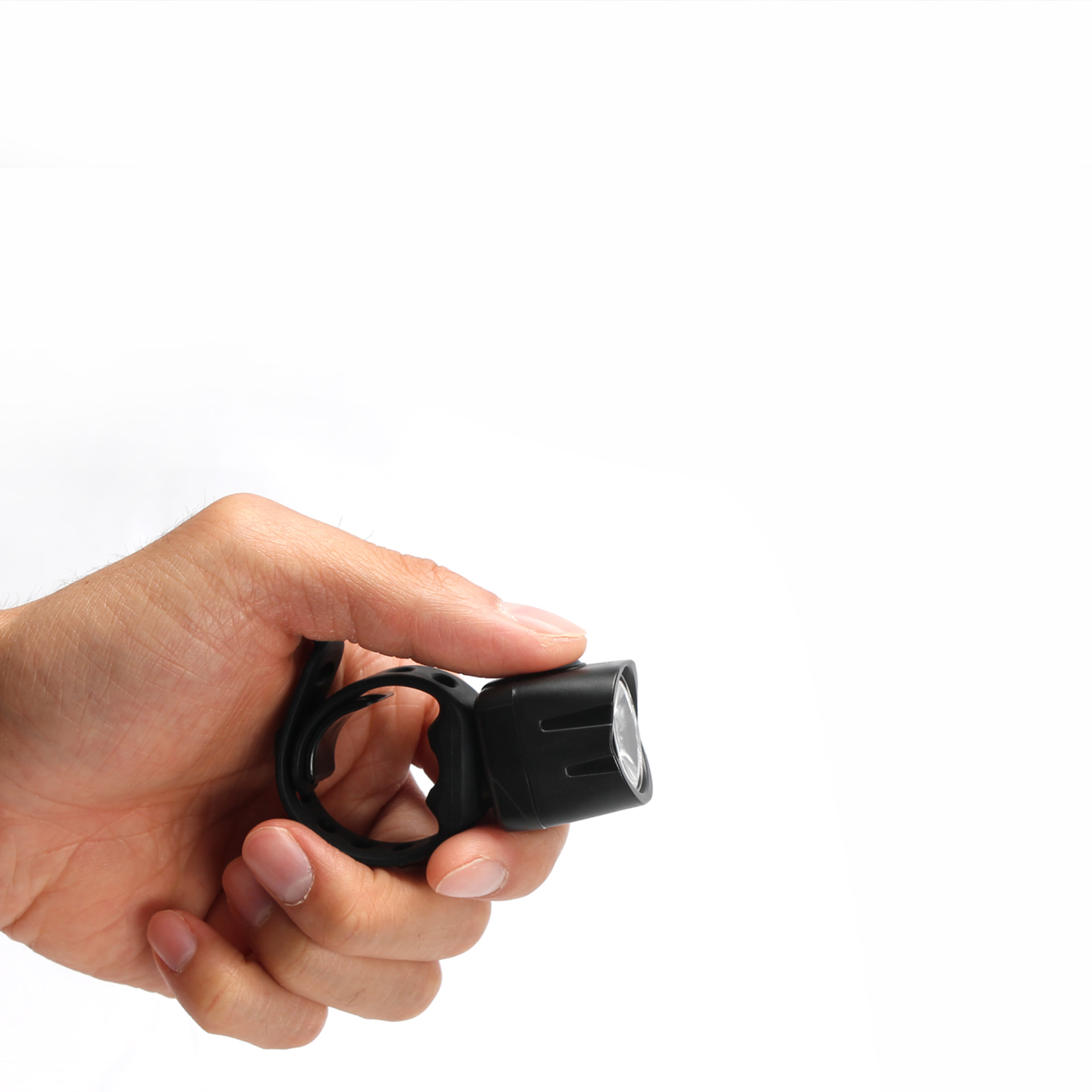 Compact Cygolite headlight held between two fingers to show its cubic inch size