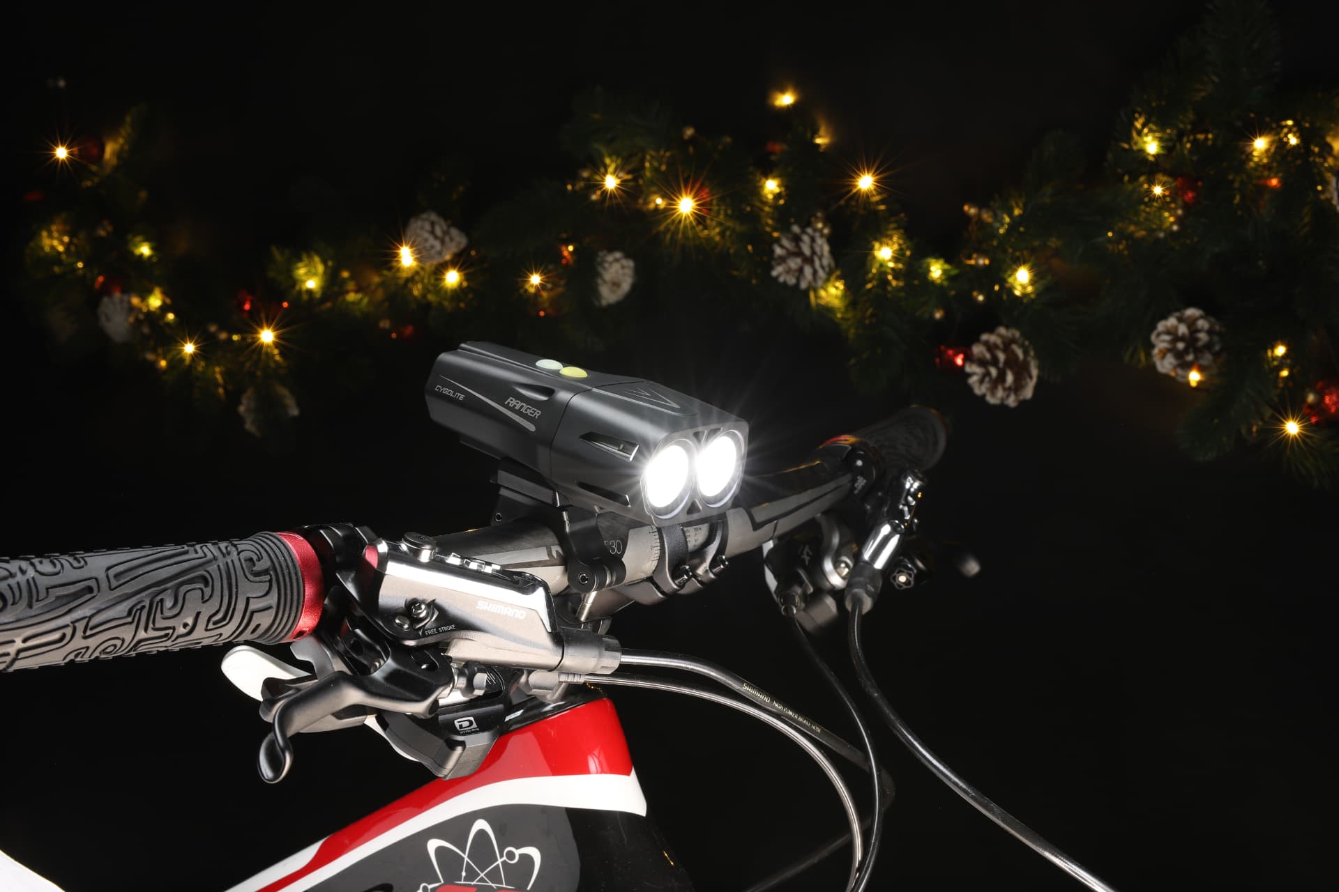 Cygolite Ranger dual-LED headlight lit on mountain bike handlebars